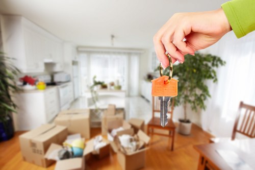 Professional movers handling furniture protection during a central London home relocation