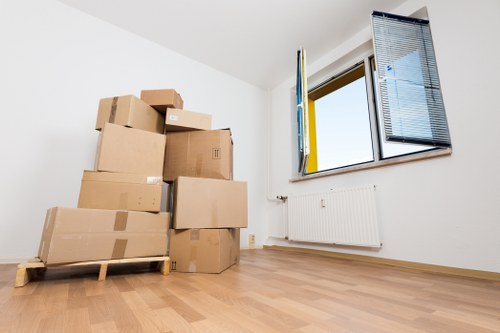 Moving boxes, protective wrap, and labels prepared for packing